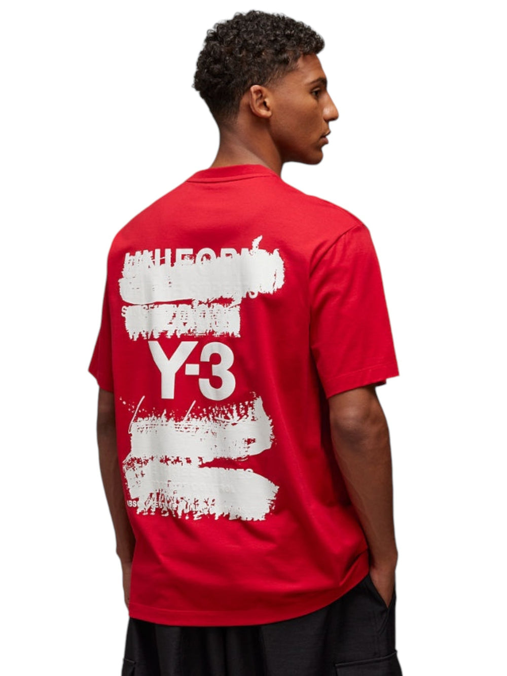 An individual dressed in an ADIDAS x Y-3 JN3751 U GFX SS Tee Powred, featuring classic white text and design on the back, made from soft cotton fabric.