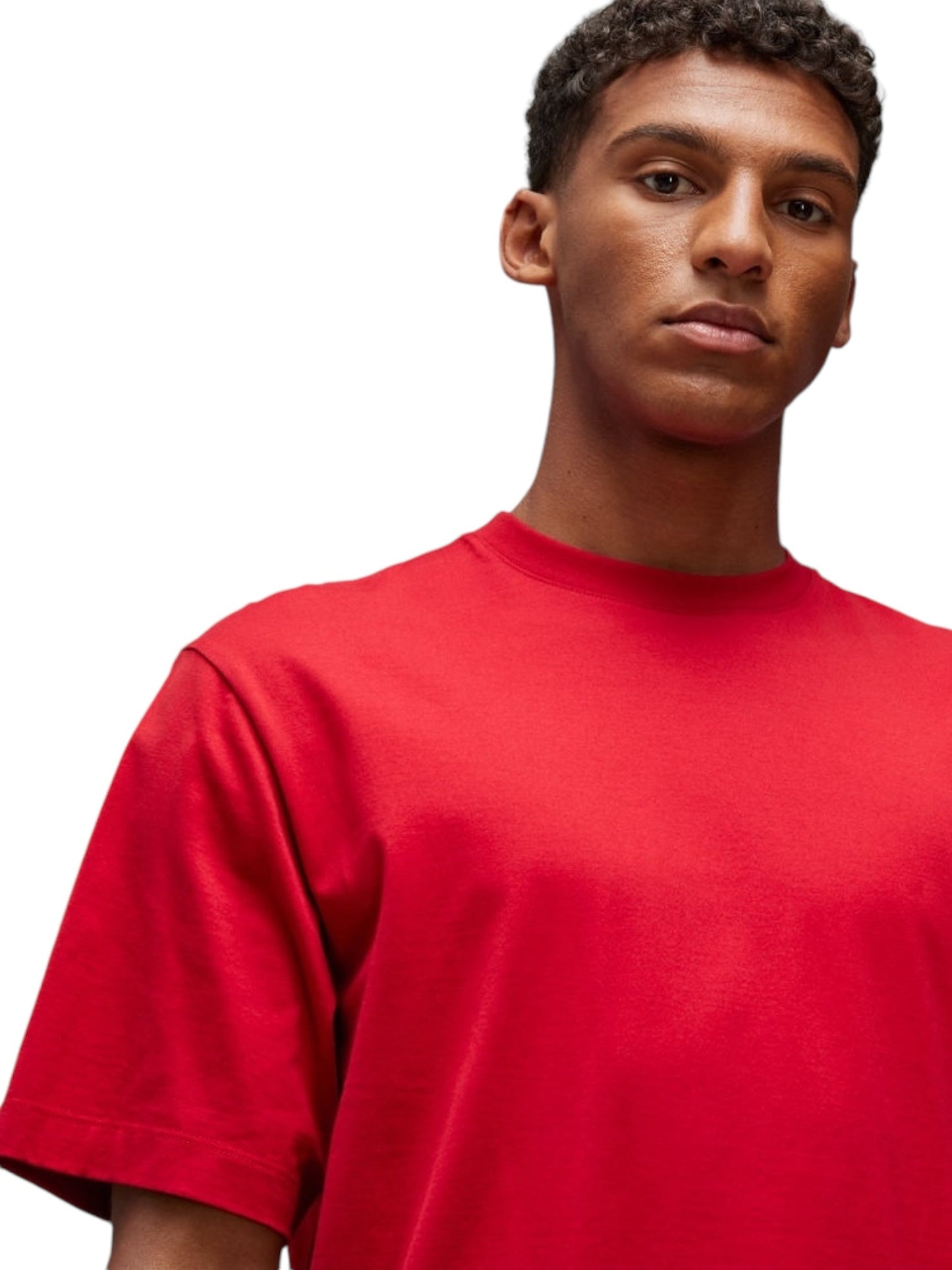 A person wearing the Y-3 JN3751 U GFX SS Tee in Powred, from the ADIDAS x Y-3 collection and crafted from soft cotton fabric, stands against a plain white background.