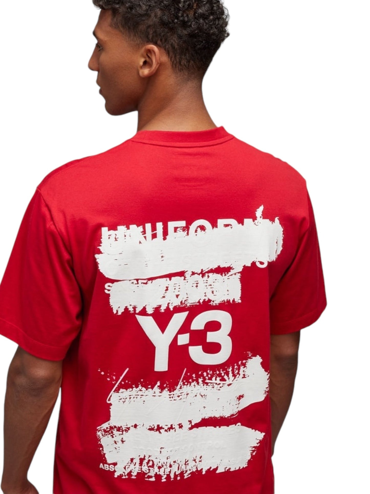 A person wearing the Y-3 JN3751 U GFX SS Tee Powred, a red T-shirt from ADIDAS x Y-3, made from soft cotton fabric and featuring white Y-3 branding along with an abstract text design on the back.