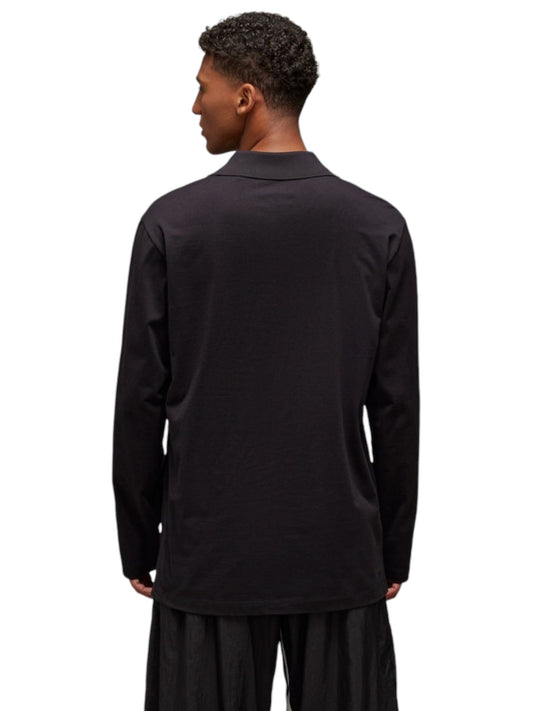 An individual is seen from behind, clad in a Y-3 JN4876 U GFX Logo long-sleeve black shirt by ADIDAS x Y-3, set against a plain white background.