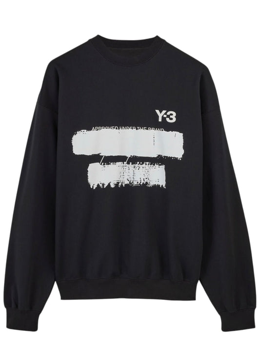 Experience the chic design of the ADIDAS x Y-3 JN4881 U GFX Crew Black sweatshirt, showcasing "Y-3" at the top right and two white brushstroke patterns on the front. Made from a cotton-poly blend, it offers timeless elegance and comfort.