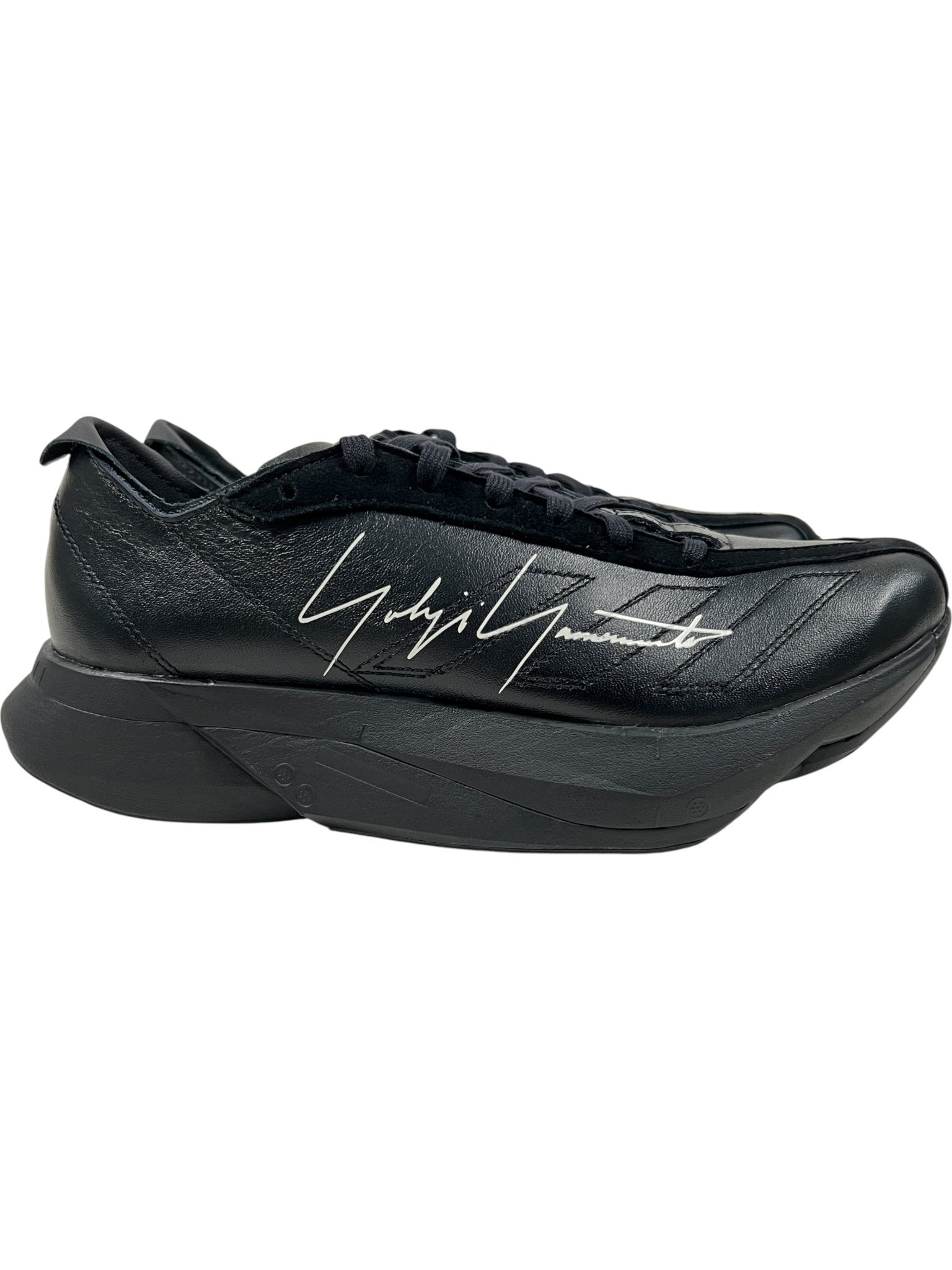 The ADIDAS x Y-3 JR4205 Y-3 Adios Pro 3.0 Black/Black sneaker features a thick sole, black laces, and a white Yohji Yamamoto signature on the side.