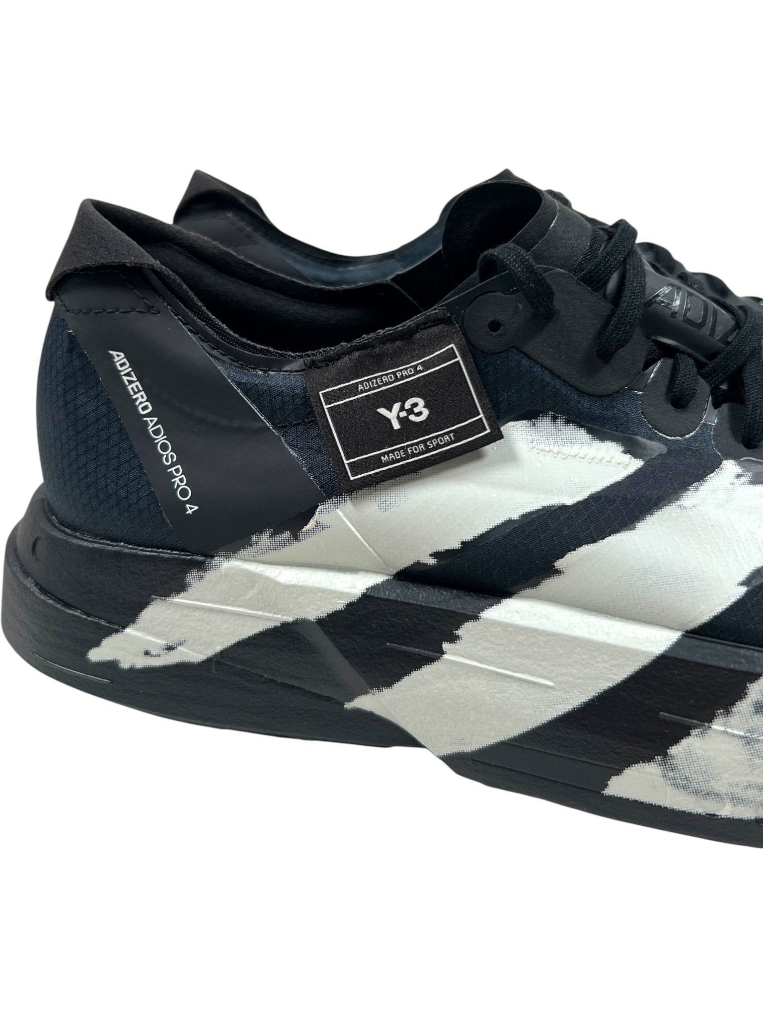 The ADIDAS x Y-3 JR6655 ADIOS PRO 4 M in Black/Black-CWhite features bold painted stripes, Lightstrike Pro cushioning, and a visible Y-3 label on the side.