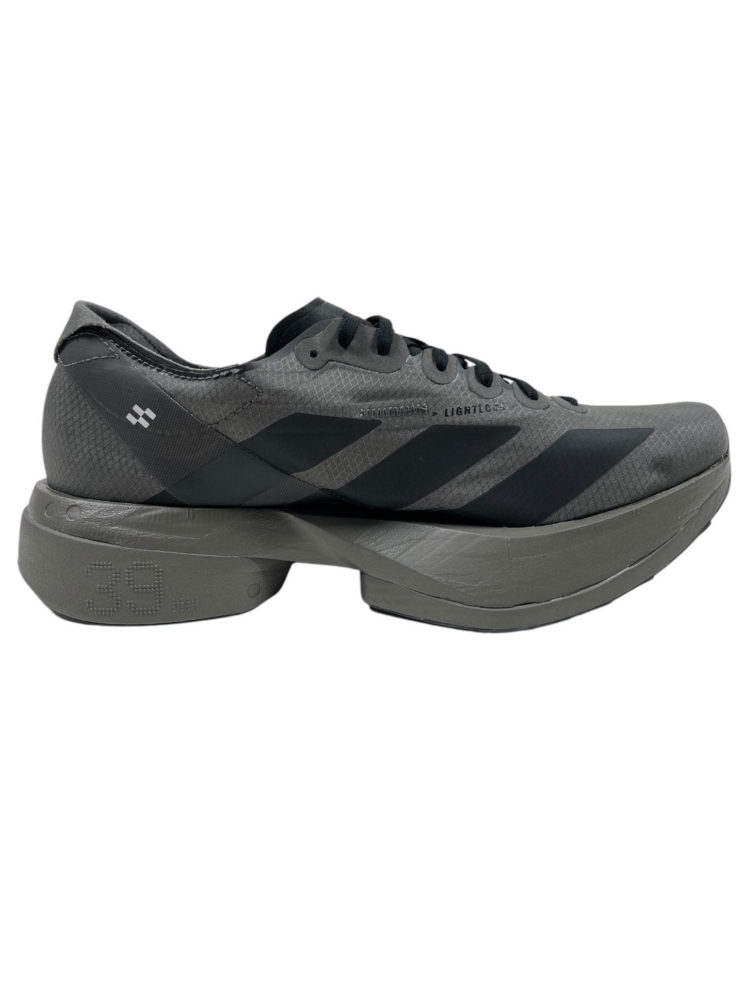 The Y-3 JS3155 Y-3 Adios Pro 4 M Cinder/Black by ADIDAS x Y-3 is a sleek sneaker featuring a gray and black design with the iconic 3-Stripes logo on its thick sole.