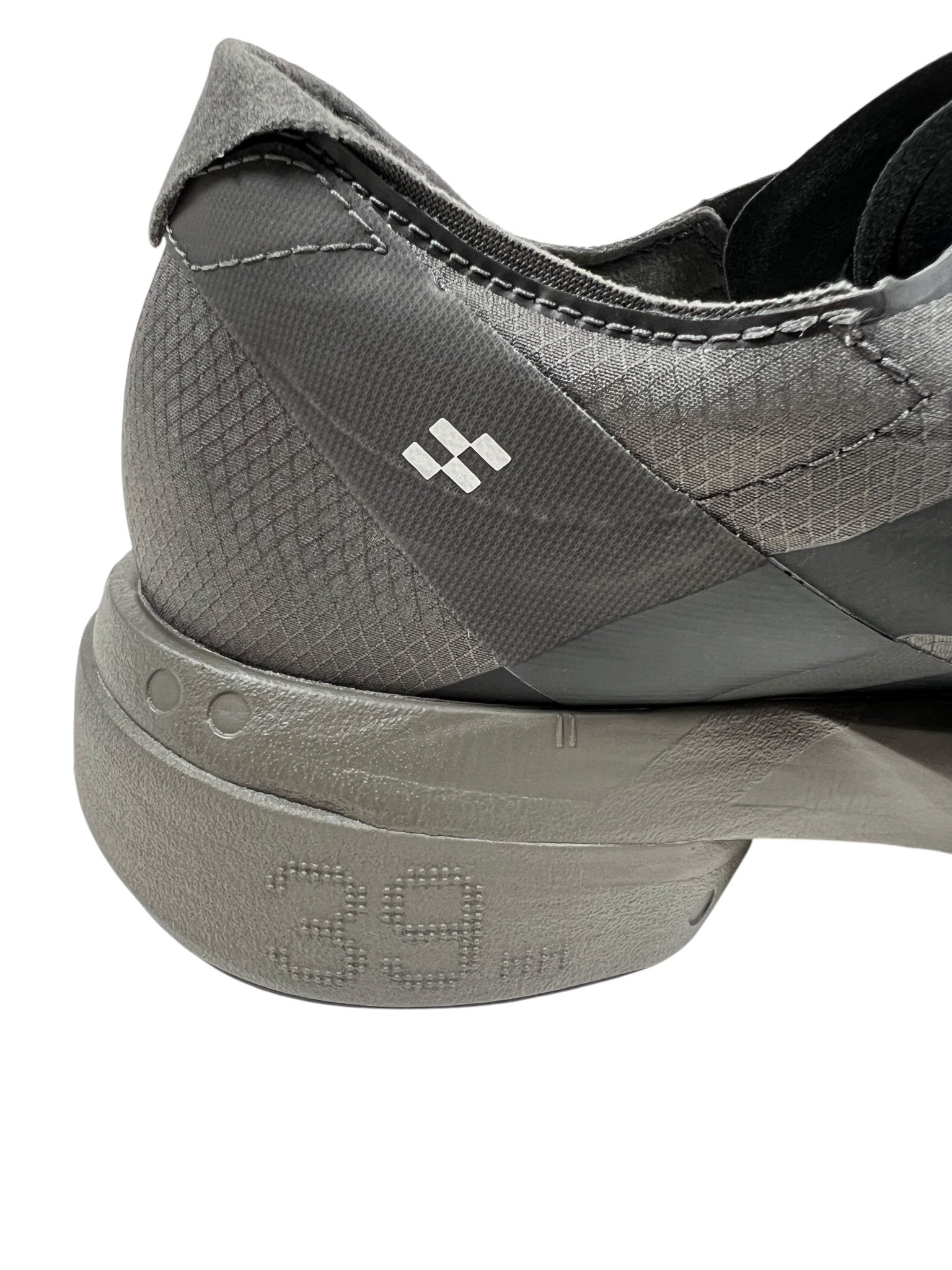 Close-up of the heel and sole of an ADIDAS x Y-3 JS3155 Y-3 Adios Pro 4 M in Cinder/Black, showcasing a geometric pattern with the embossed size "39." The subtle iconic 3-Stripes logo highlights its sleek, modern look.