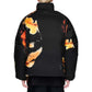 A person with short blond hair is seen from behind wearing the ADIDAS x Y-3 KA2364 M AOP Puff JKT Multco/Black, a puffer jacket with PrimaLoft insulation, black polyamide fabric, and bold orange-yellow abstract patterns.