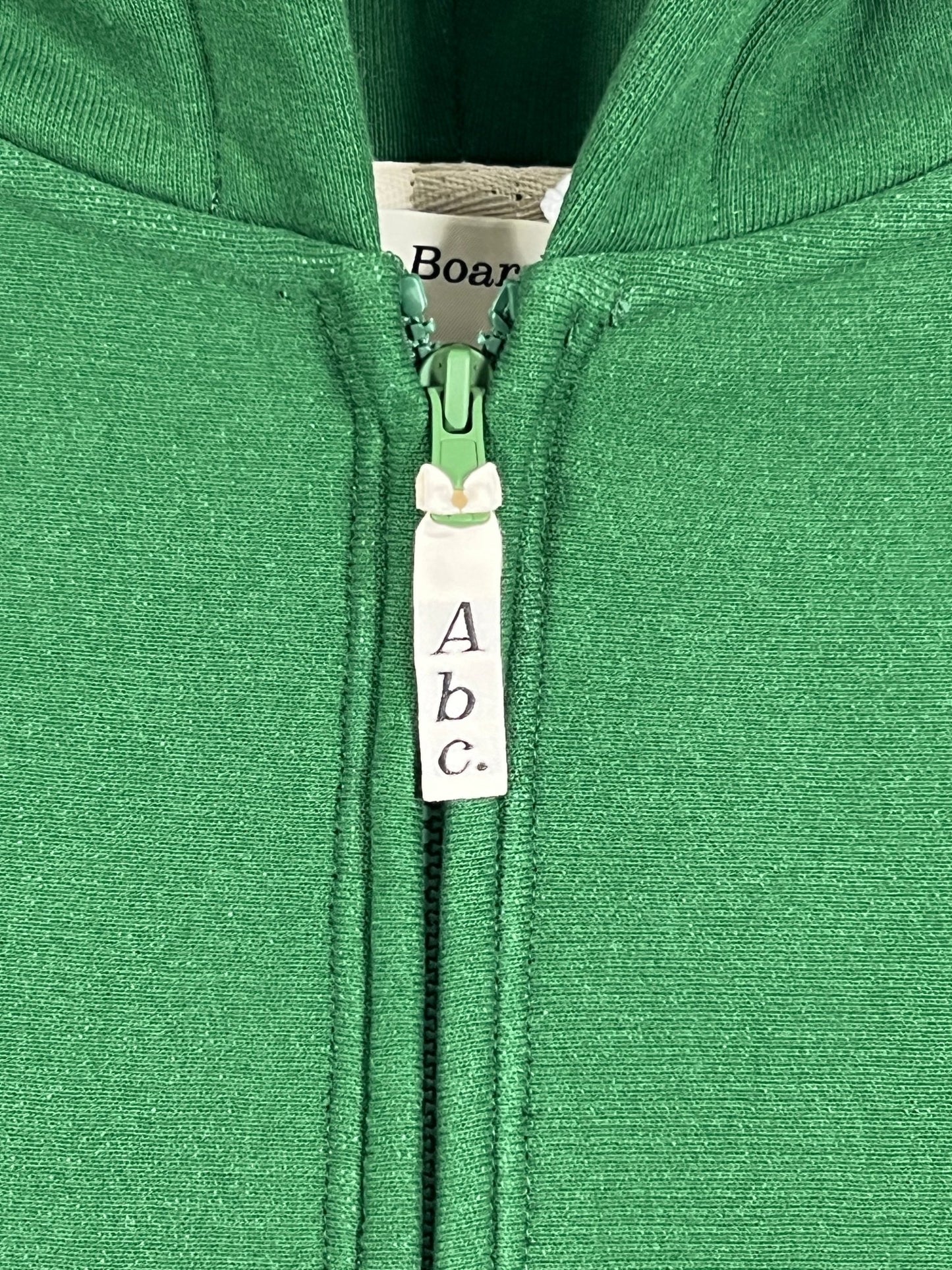 A green zip-up hoodie with the ADVISORY BOARD CRYSTALS logo on it.