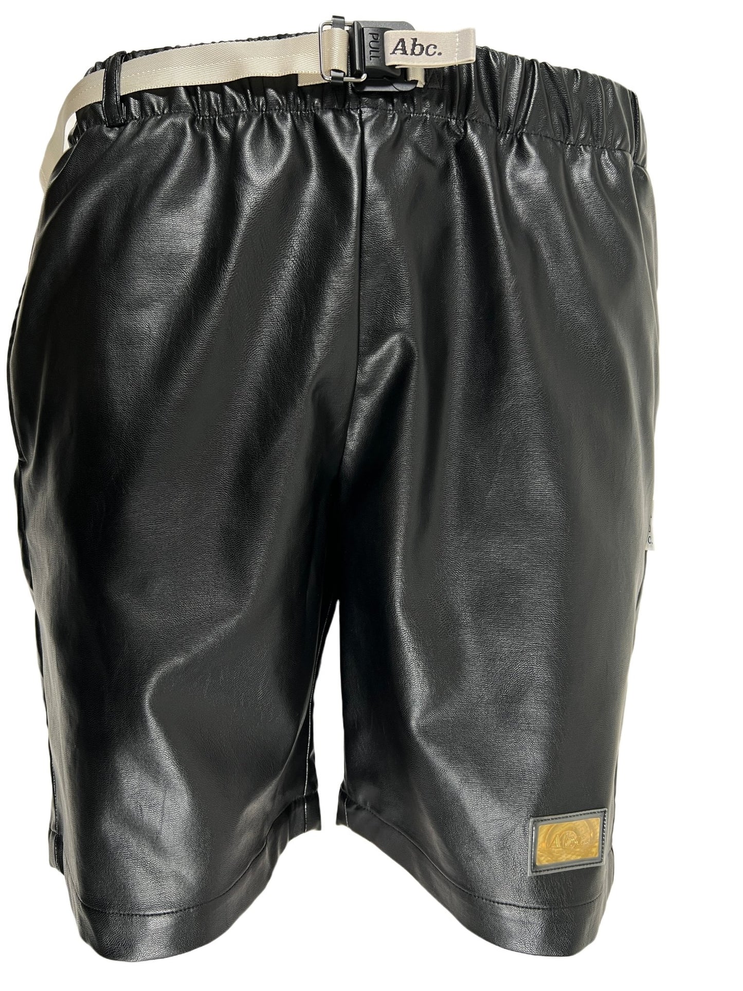 A black Advisory Board Crystals faux leather work shorts with a belt and buckle.