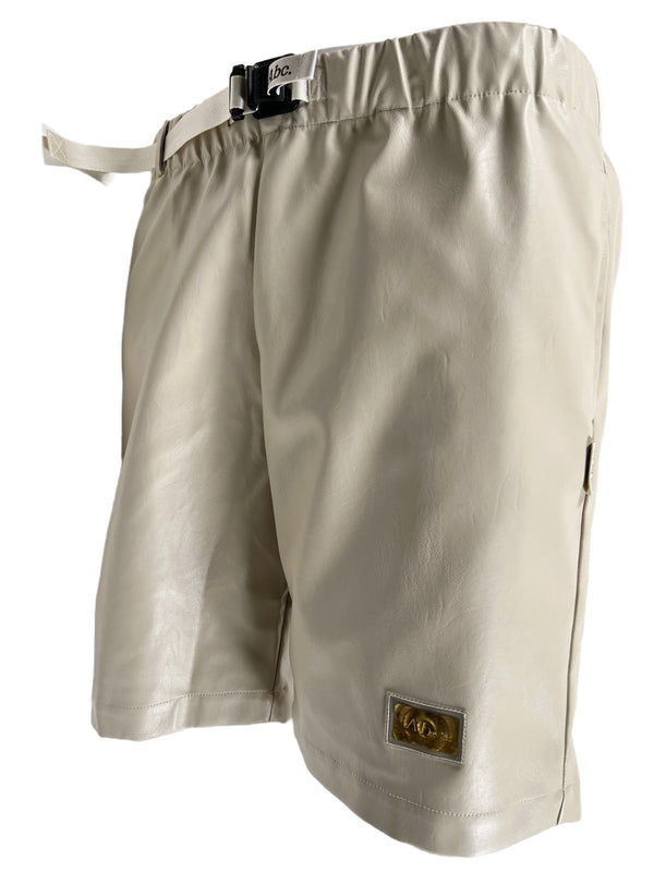 A Feldspar Ecru faux leather short by Advisory Board Crystals with a buckle on the side.