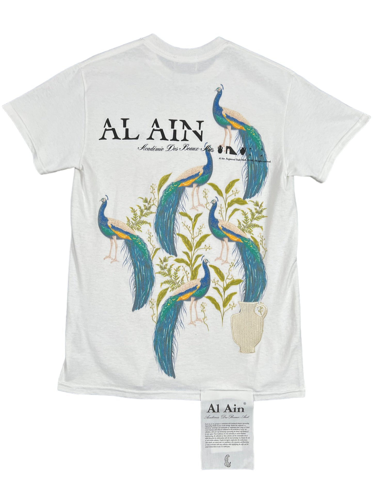 AL AIN AMHX S121 PEACOCK BLANC by AL AIN featuring "AL AIN" and six peacocks in a large graphic detail on the back. There is also a small embroidered brand name label sewn at the bottom front.