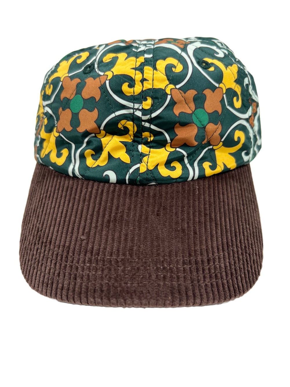 A DROLE DE MONSIEUR hat with a floral pattern on it, featuring a buckle closing system.