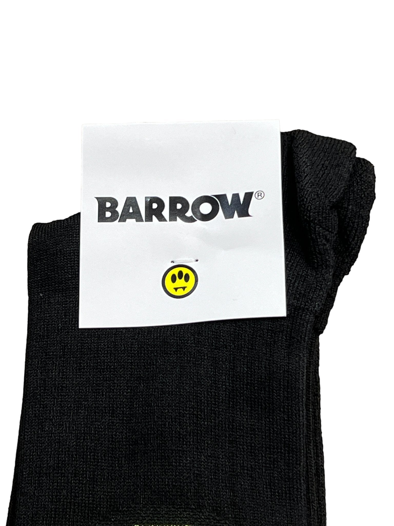 These Barrow S4BWUASO140 unisex socks feature a black design with a white label displaying the word "BARROW" and a yellow smiling face with black eyes and mouth. Expertly made in Italy, these socks exemplify impeccable quality.