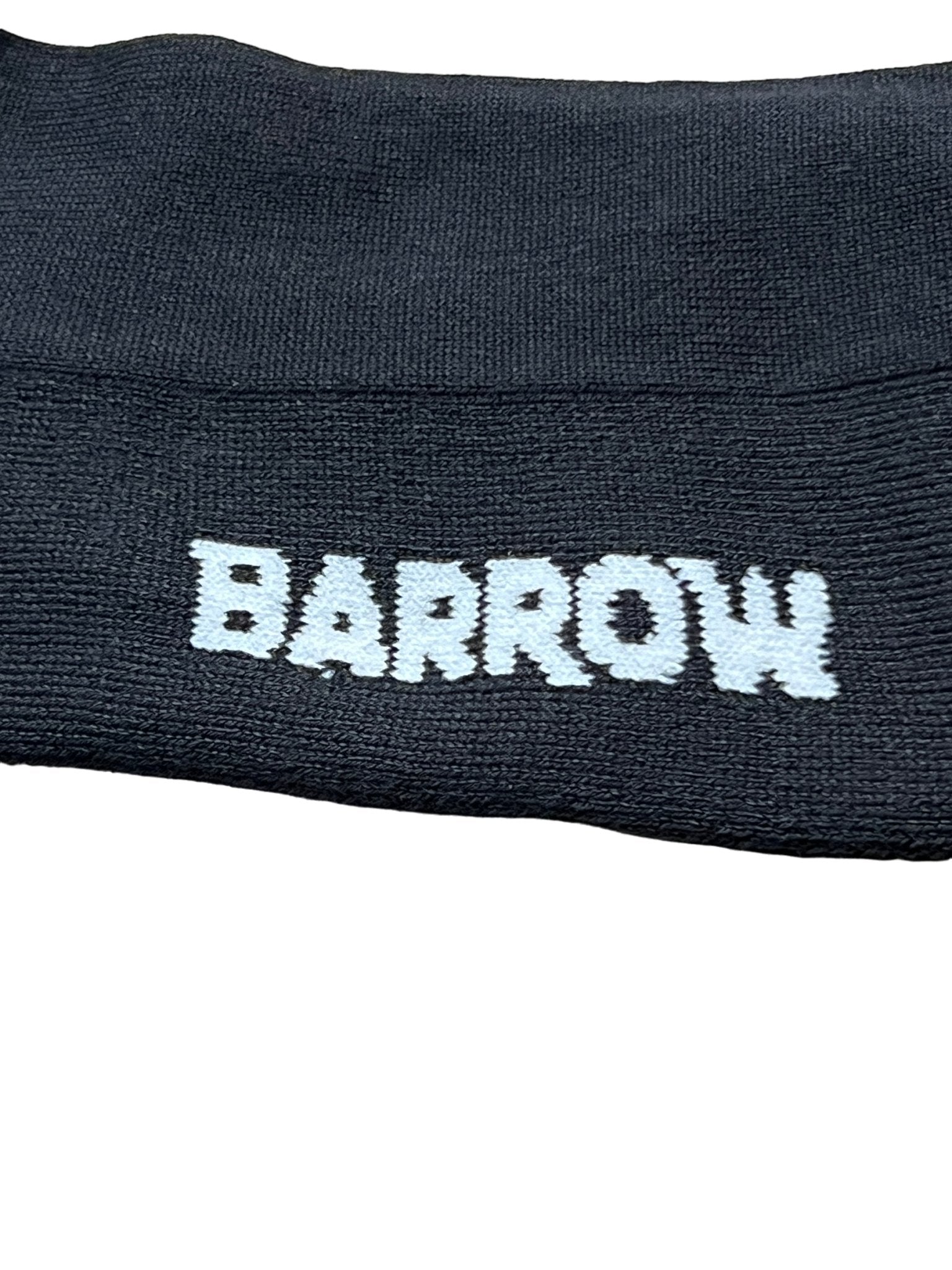 Close-up of a black fabric featuring "BARROW" embroidered in white uppercase letters, echoing the precision and quality associated with BARROW's Made In Italy craftsmanship from their S4BWUASO140 Unisex Socks collection.