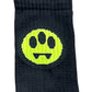 The Barrow S4BWUASO140 Socks Unisex, by BARROW, feature a playful pattern with a yellow smiley face, black eyes, and a zigzag mouth set against a sophisticated black background and are crafted in Italy.