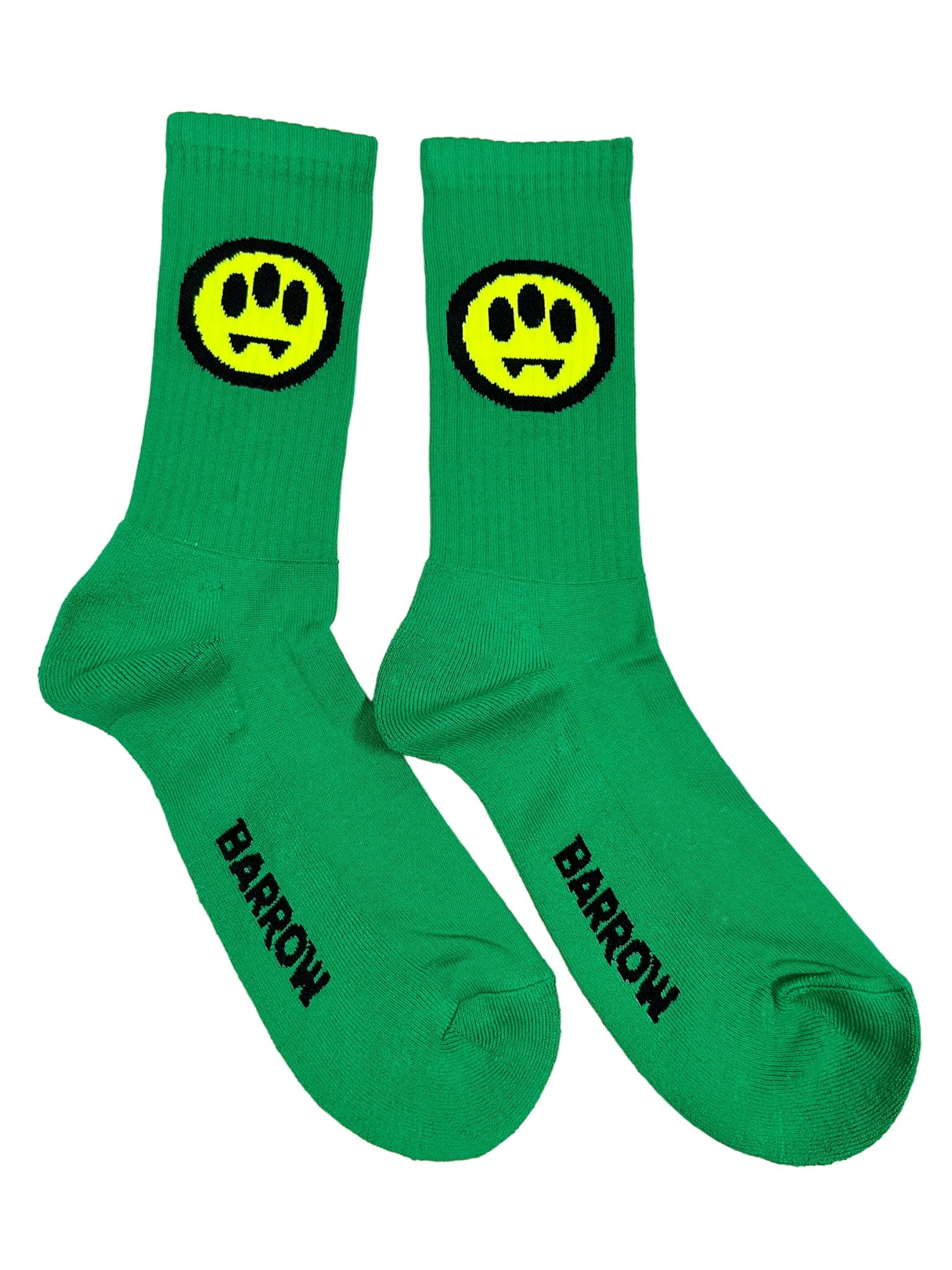 The Barrow S4BWUASO140 Socks Unisex feature a lively green design with a playful yellow smiley face sporting fangs. The word "BARROW" is prominently printed in black on the sole of each sock. Made in Italy, these vibrant socks by BARROW add a distinctive touch to any ensemble.