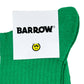 A green towel adorned with a prominent BARROW brand label and a small, cheerful yellow smiley face icon. Expertly crafted with the same attention to detail as our distinctive Barrow S4BWUASO140 unisex socks made in Italy, it introduces a playful yet elegant flair to your bathroom collection.