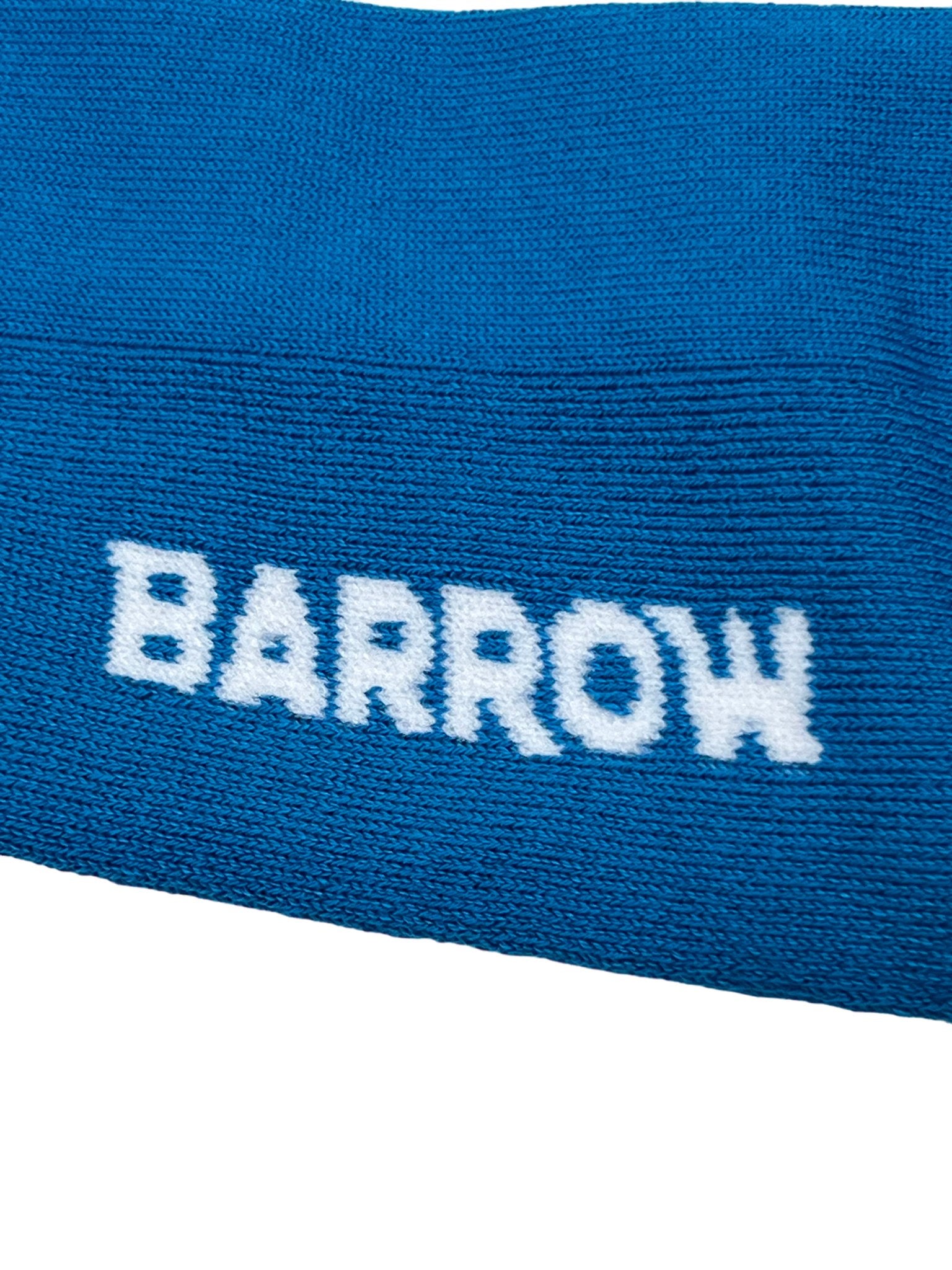 Close-up of the BARROW S4BWUASO140 blue fabric, featuring "BARROW" in white text—reminiscent of the striking designs found on BARROW's unisex graphic socks. These are crafted with precision, capturing the essence of pieces proudly Made In Italy and embodying a perfect blend of style and craftsmanship.