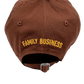 A brown DSQUARED2 BCM0611 BASEBALL CAP GABARDINE-NOCCIOLA with the word "family business" embroidered on it.