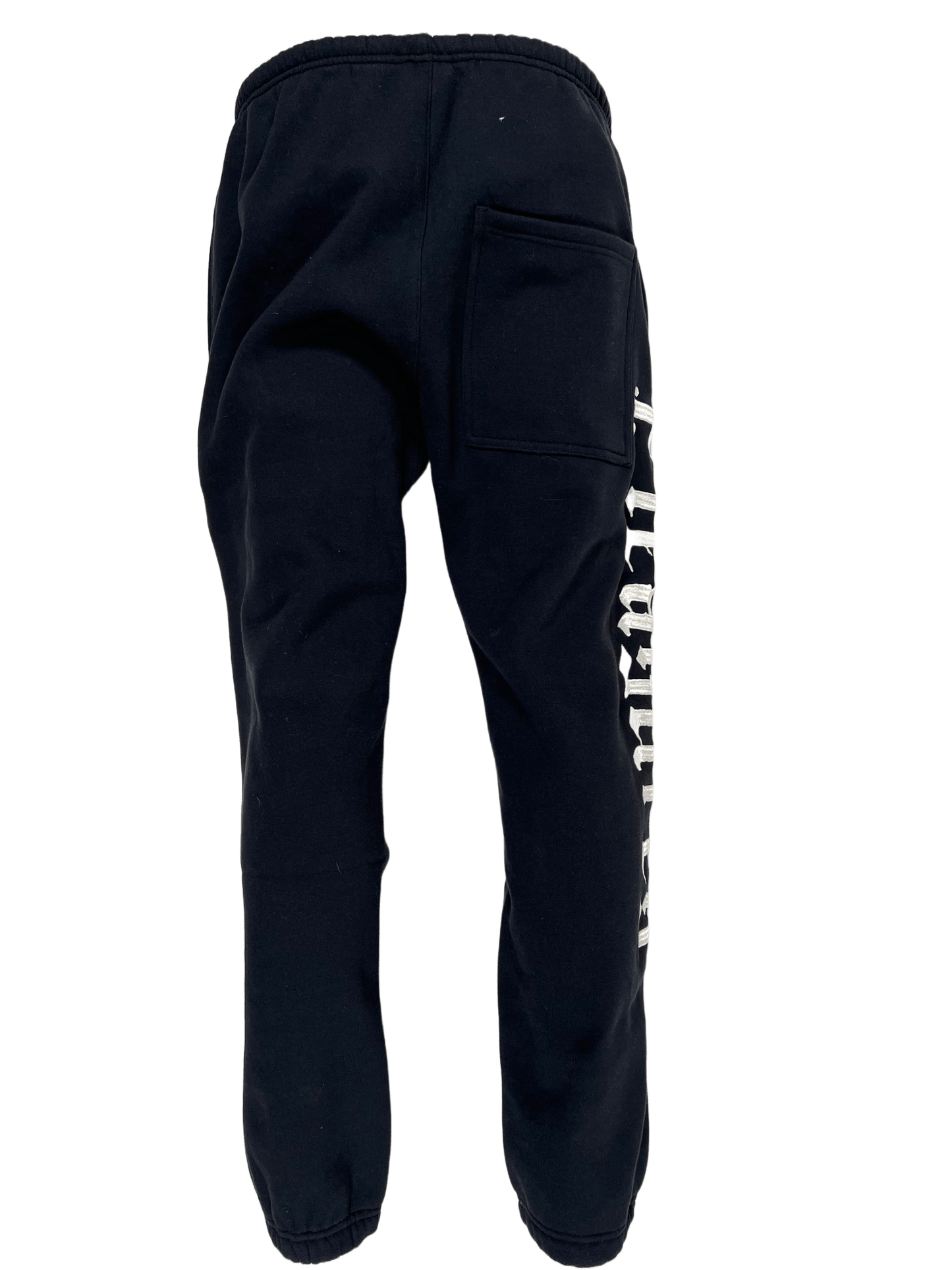 A black cotton fleece Pleasures Burnout Sweatpants with a white logo print on them.