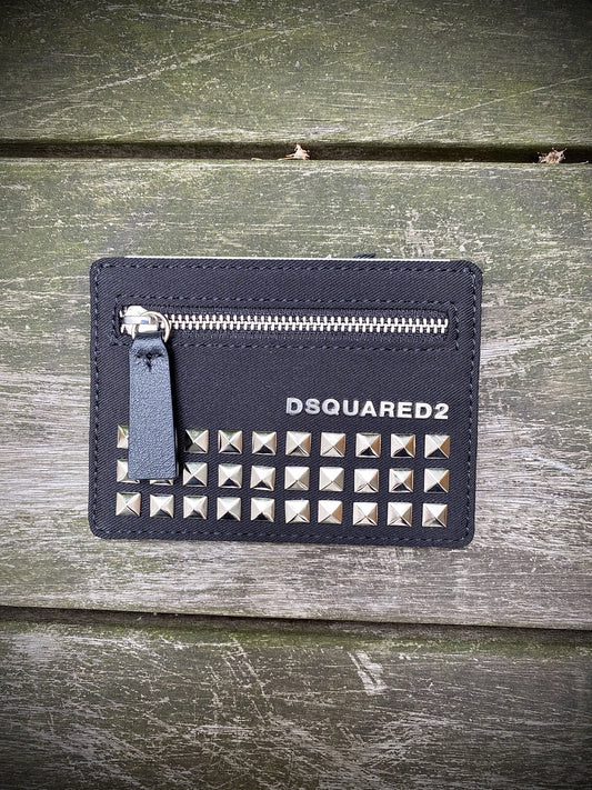 A black DSQUARED2 card holder with silver studs on it.