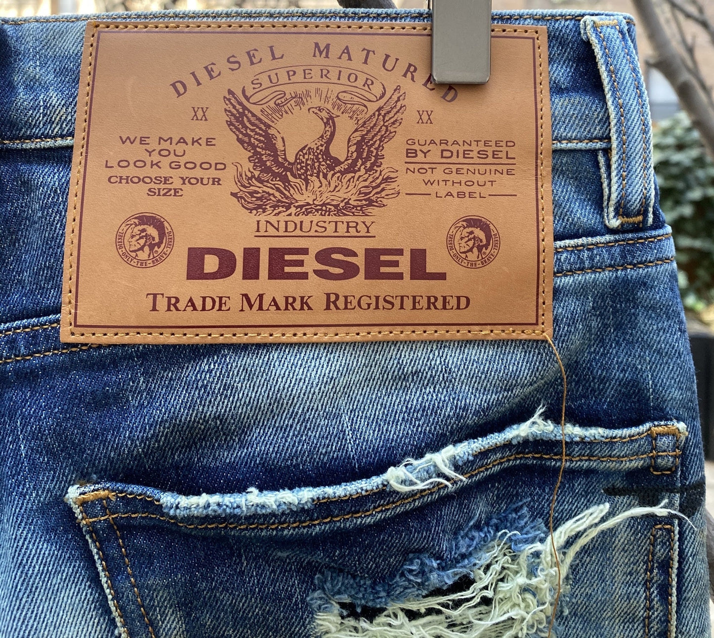 A pair of faded jeans with a tag that says DIESEL D-KRAS-X-SP4 09VI DENIM.