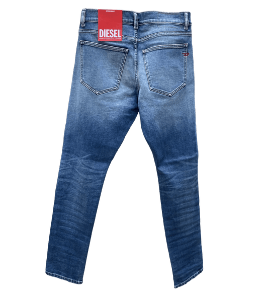 A pair of light blue DIESEL D-STRUKT 9C87 DENIM jeans with a label on the back.