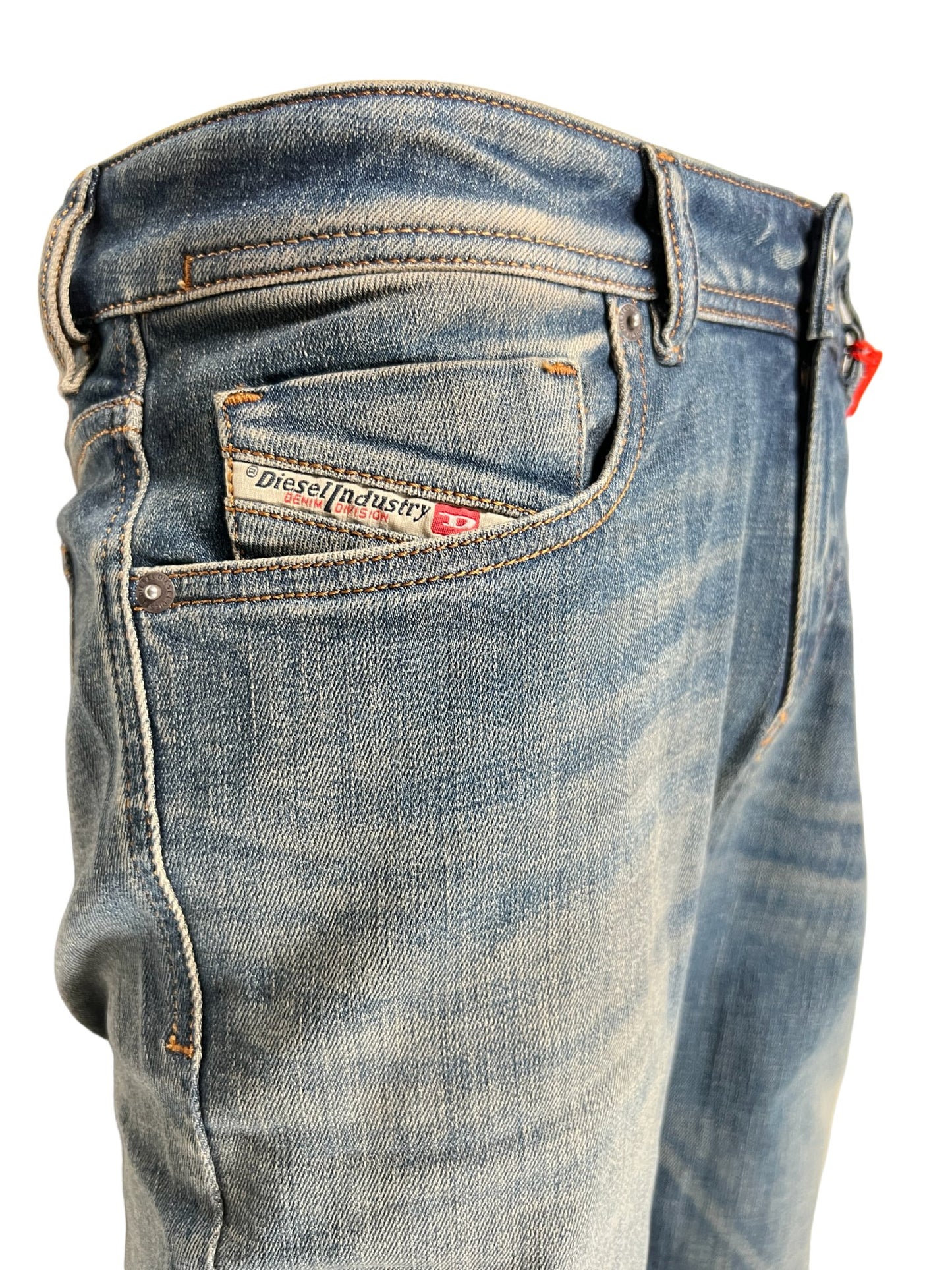 A pair of DIESEL 1979 SLEENKER 9H69 DENIM skinny style jeans with a pocket in the back.