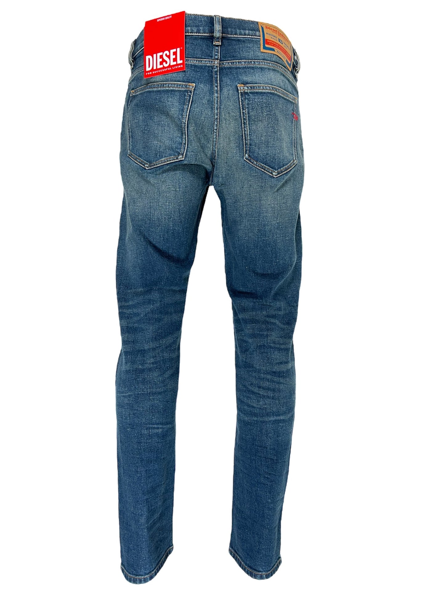 A pair of DIESEL 1979 SLEENKER 9H69 DENIM style jeans with a red tag on the back.