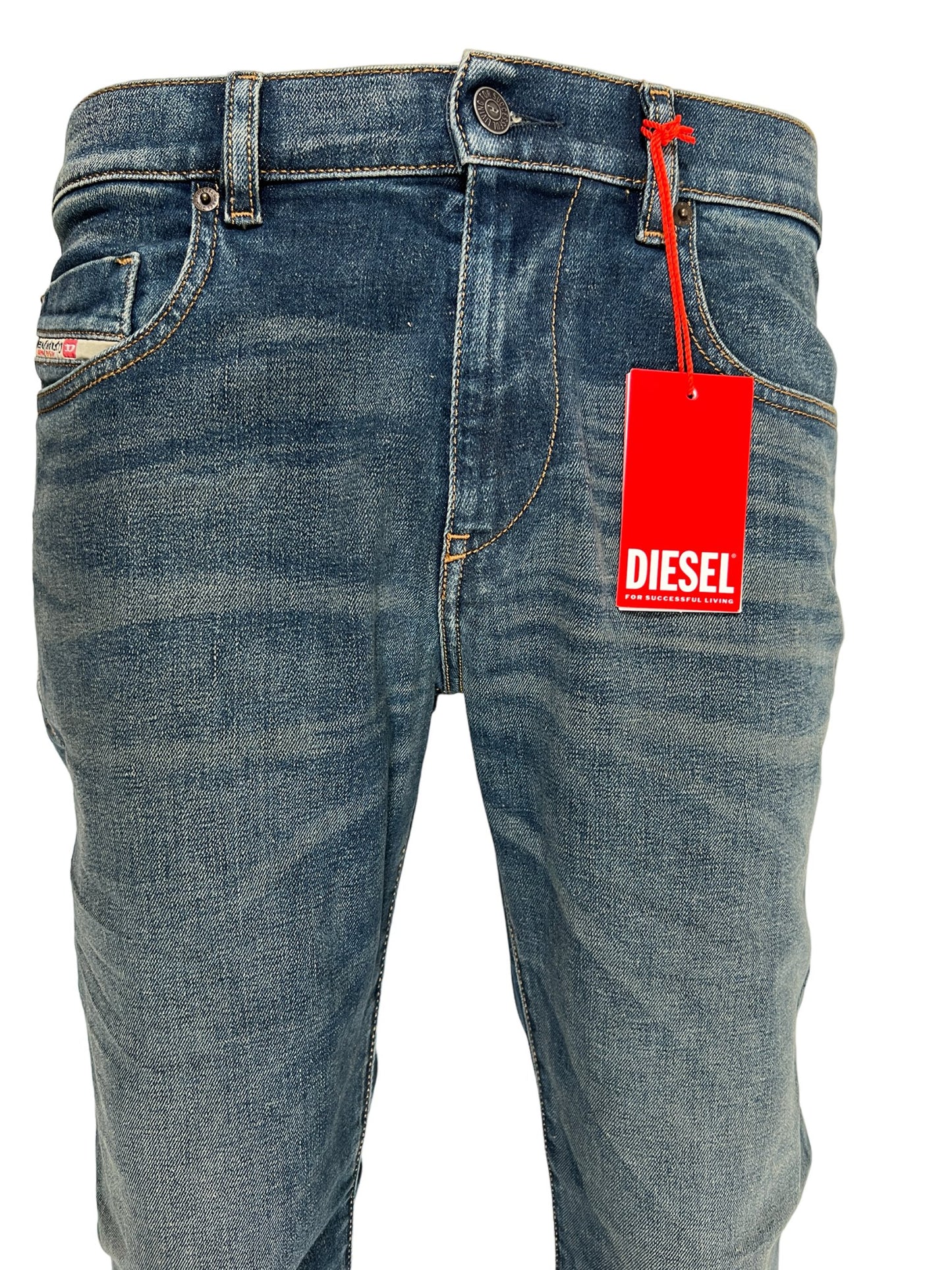 A pair of DIESEL 1979 SLEENKER 9H69 DENIM jeans with a red tag on them.