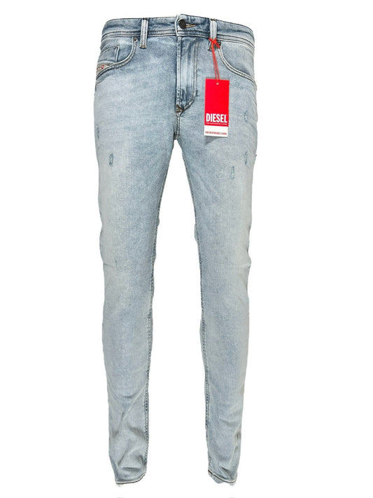 A pair of DIESEL brand skinny jeans with a red tag displayed against a white background.