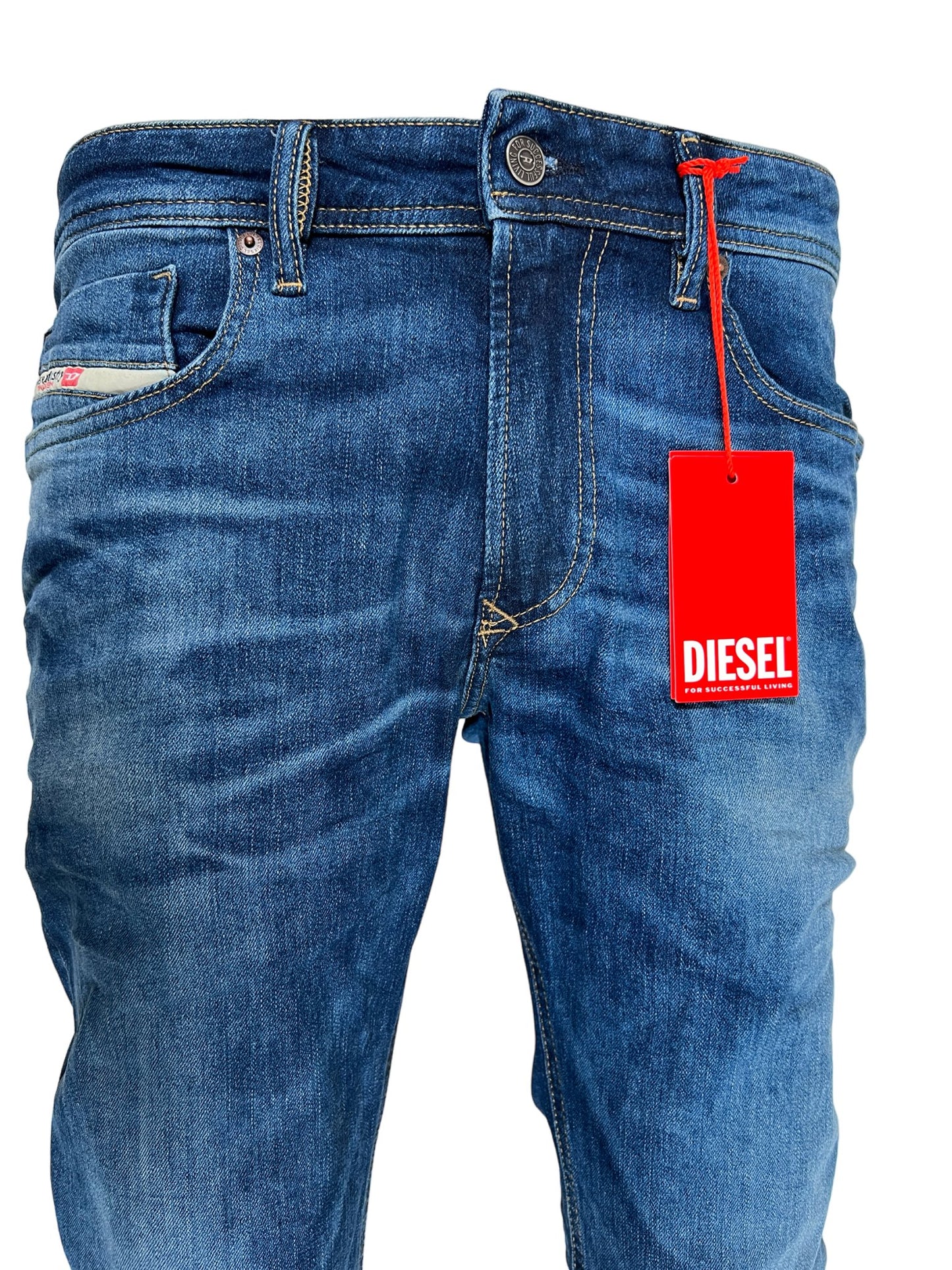 A pair of DIESEL 1979 SLEENKER PFAU DENIM jeans with a red tag on them.