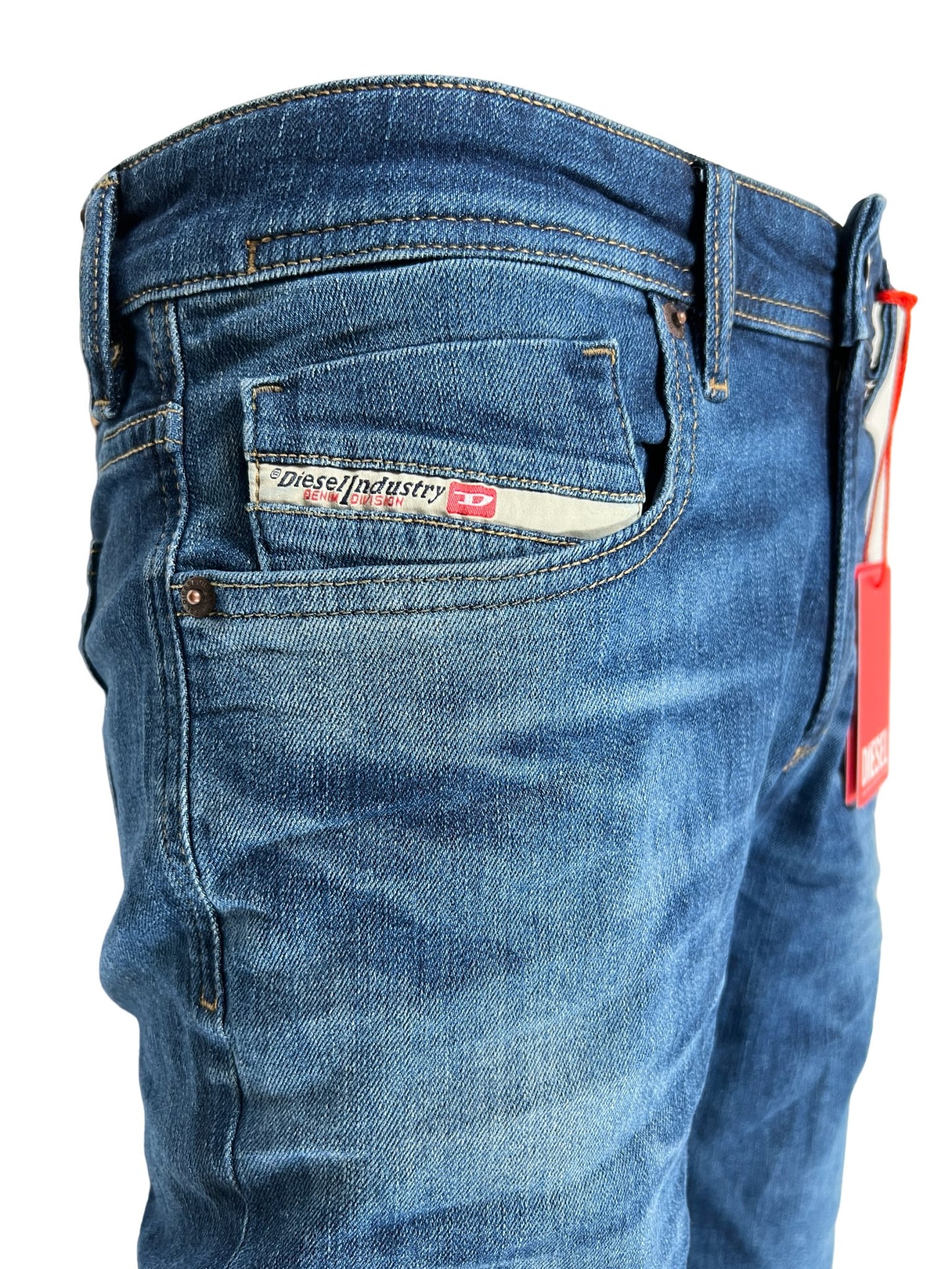 A pair of Diesel blue stretch denim jeans with a tag on the pocket.