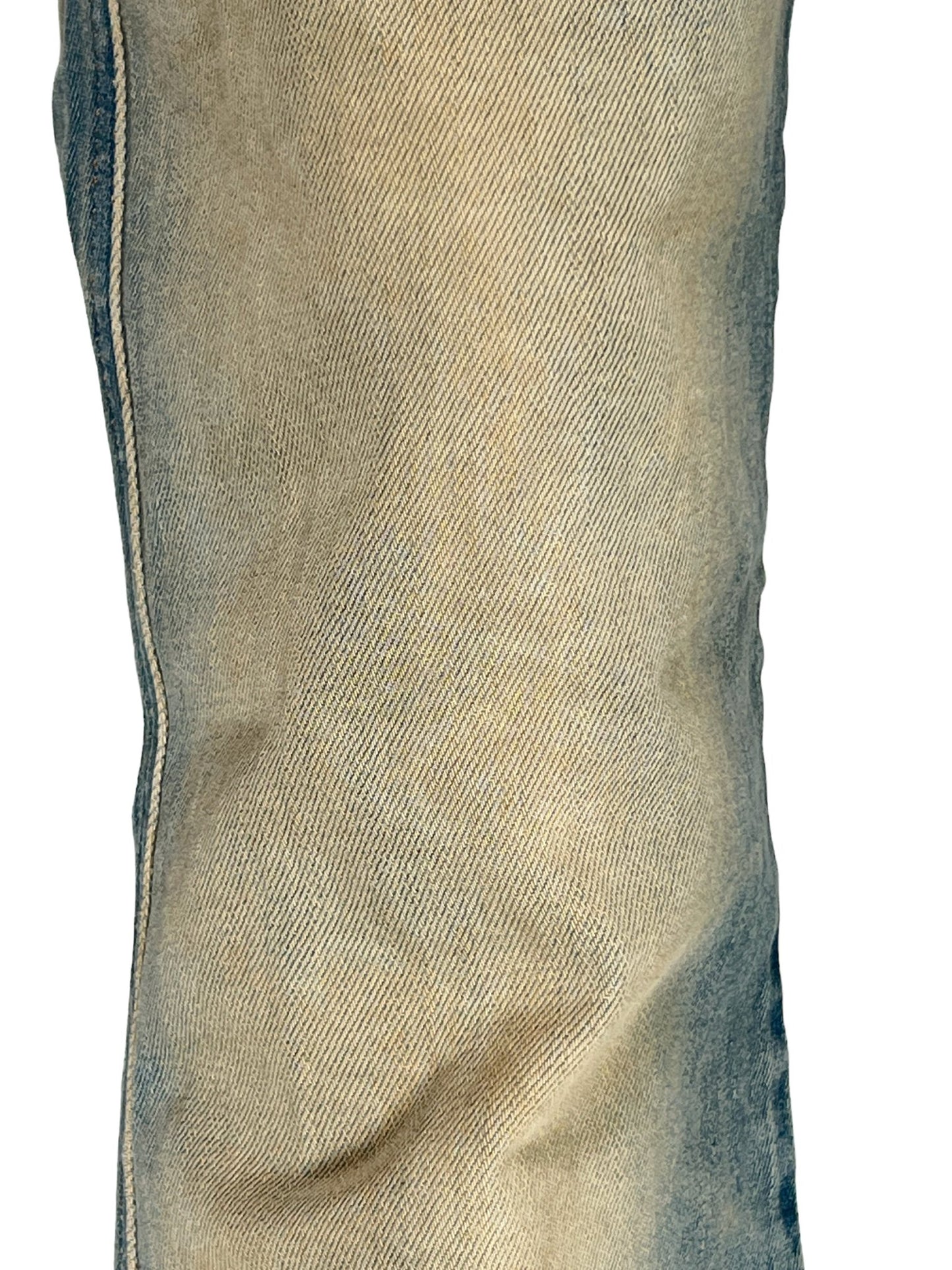 Close-up of a worn DIESEL 1998 D-BUCK 9H78 bootcut jeans fabric with fading colors.
