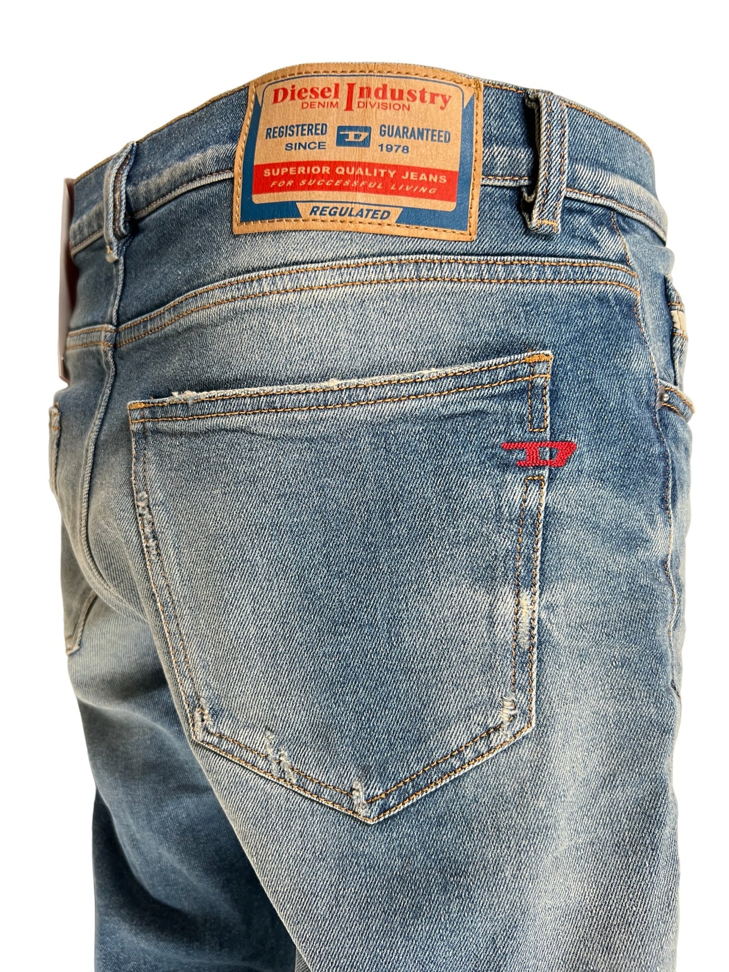A pair of DIESEL 2019 D-STRUKT 9H55 DENIM slim-fit jeans with a label on the back.