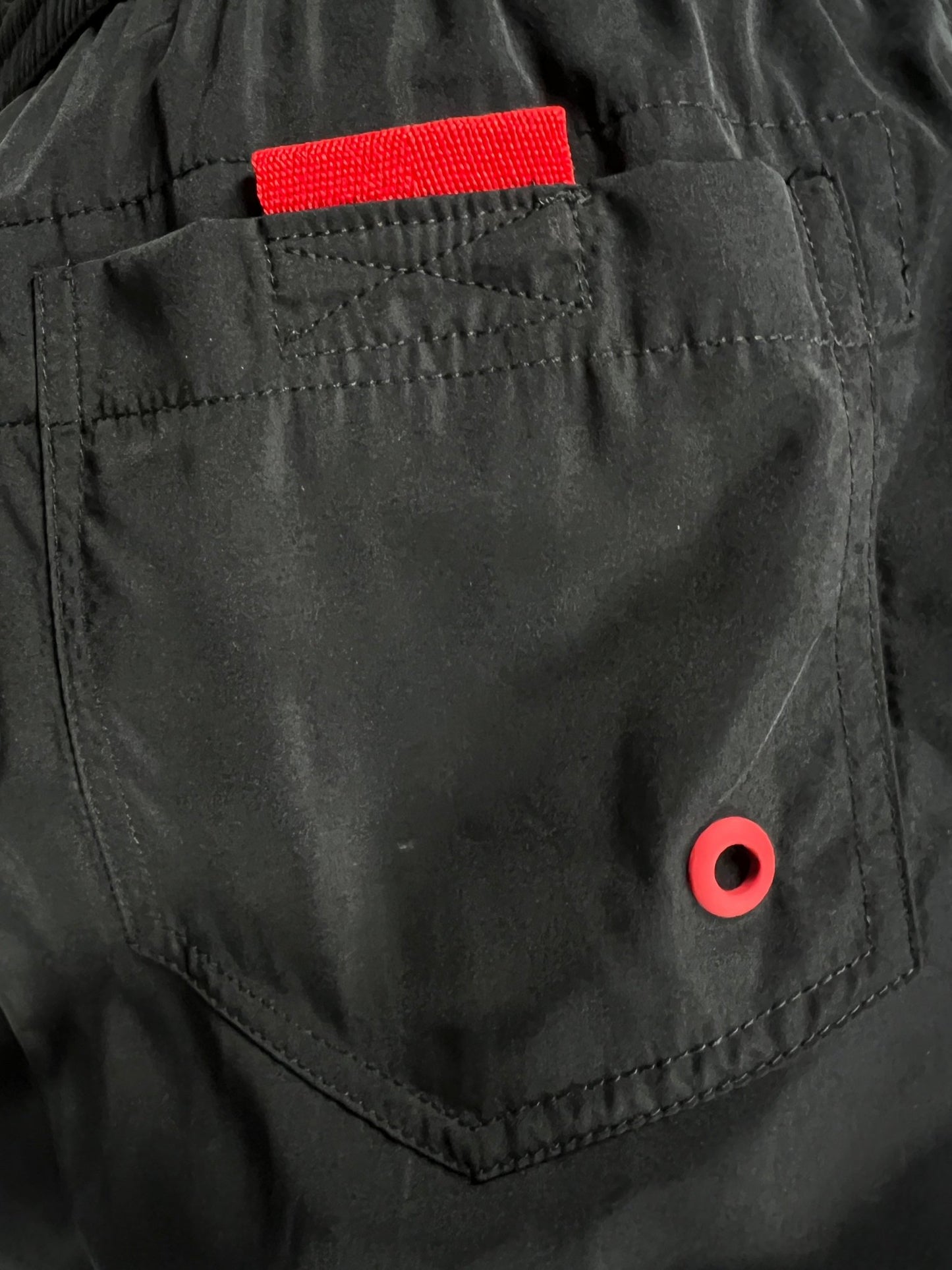Black DIESEL BMBX-MARIO-34 shorts with a red tag on the back pocket and a red buttonhole, made from 100% Polyester.