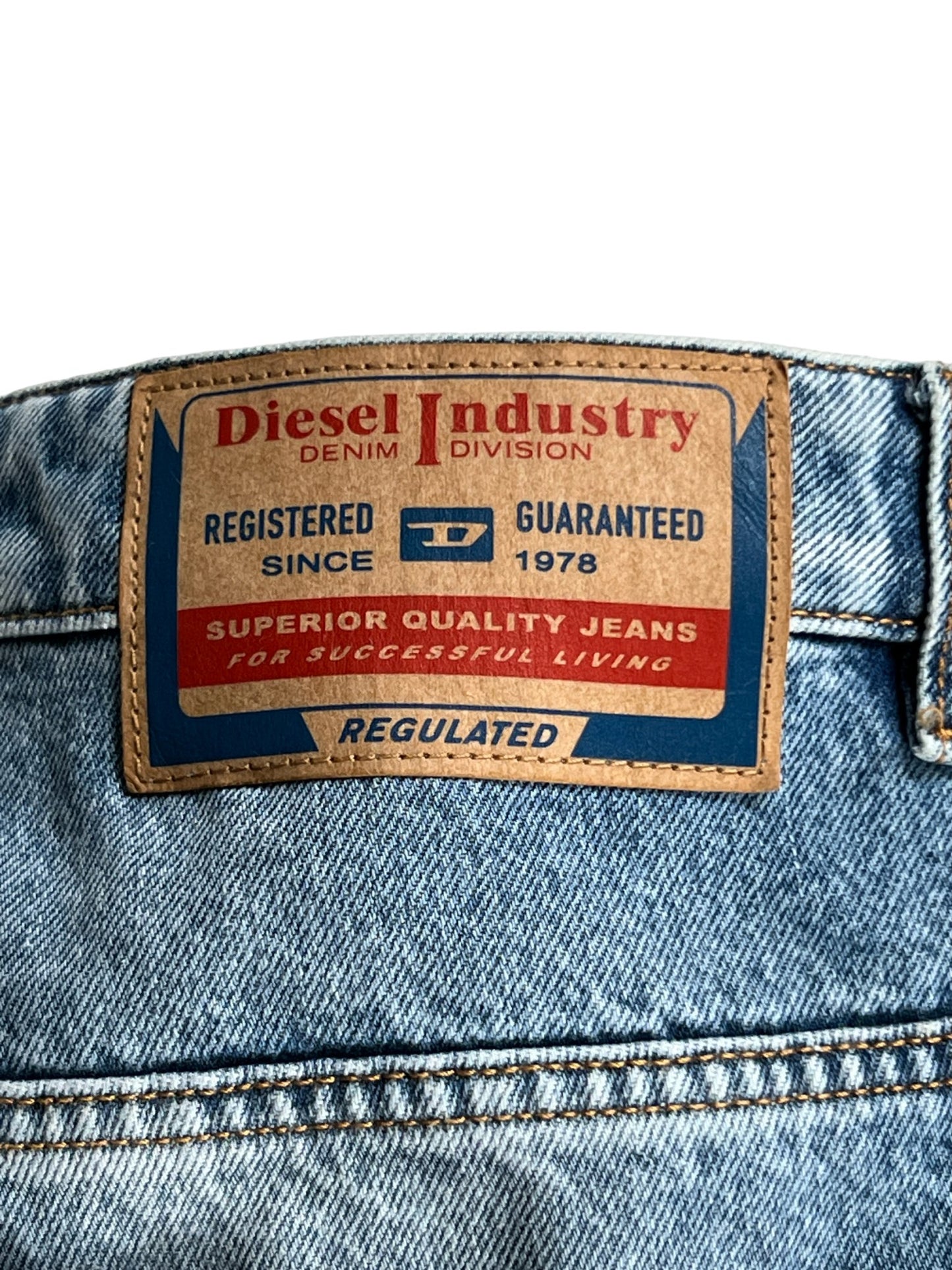 Close-up of a DIESEL D-P-5-D-S JEANS GHAW label showing brand and quality guarantee details.