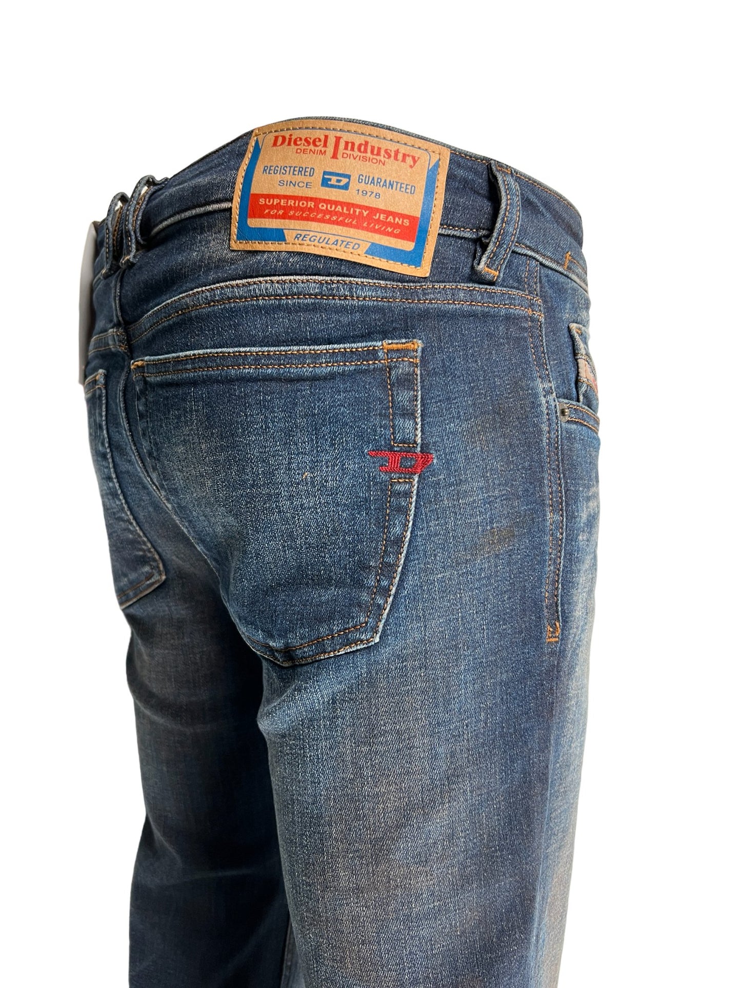 The back of a man's Diesel jeans with a label on it, made from organic cotton.