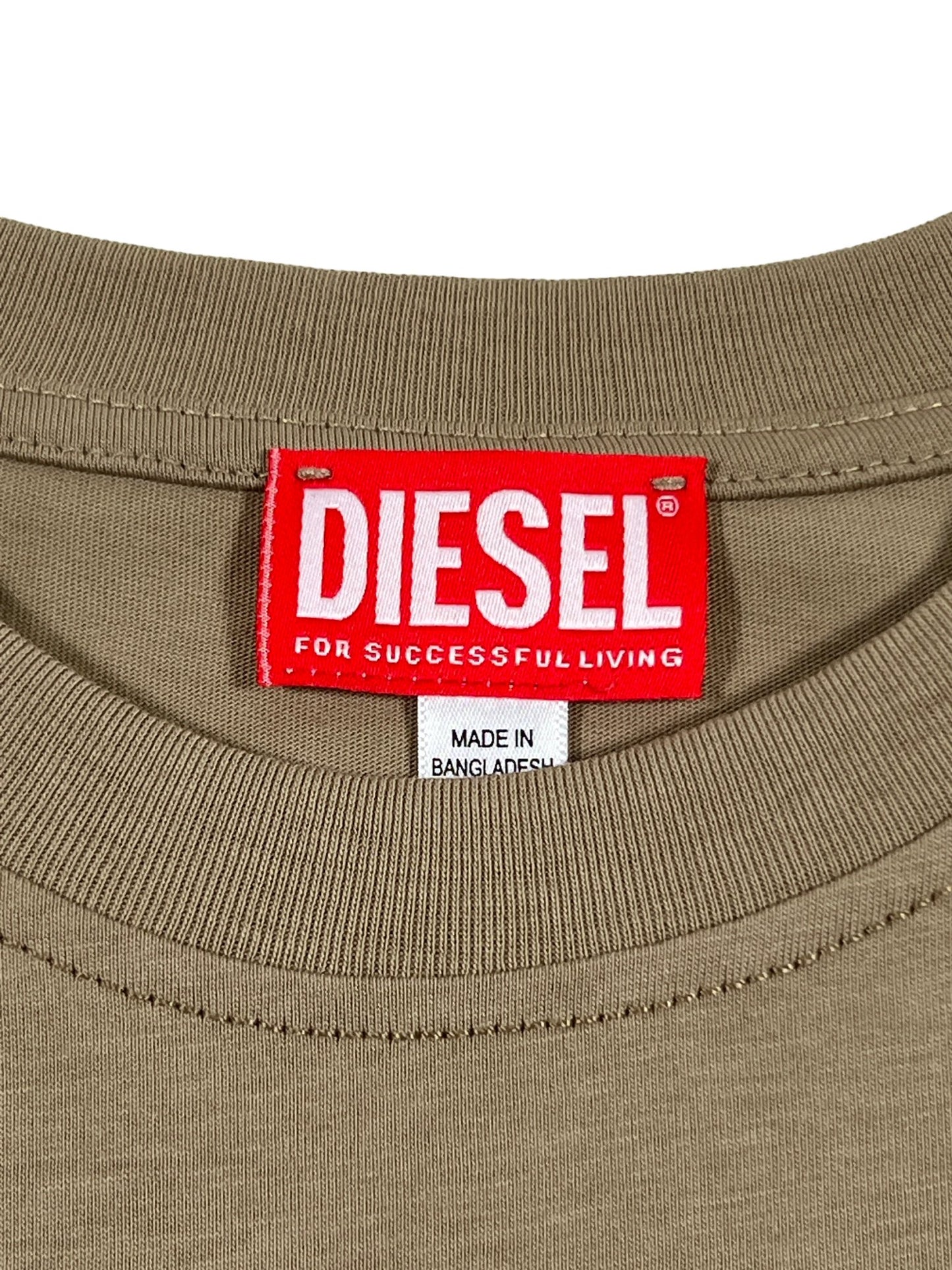 Close-up of the waistband of beige trousers, showing a red Diesel T-DIEGOR-K73 T-shirt brand label and a smaller 'made in Bangladesh' tag.