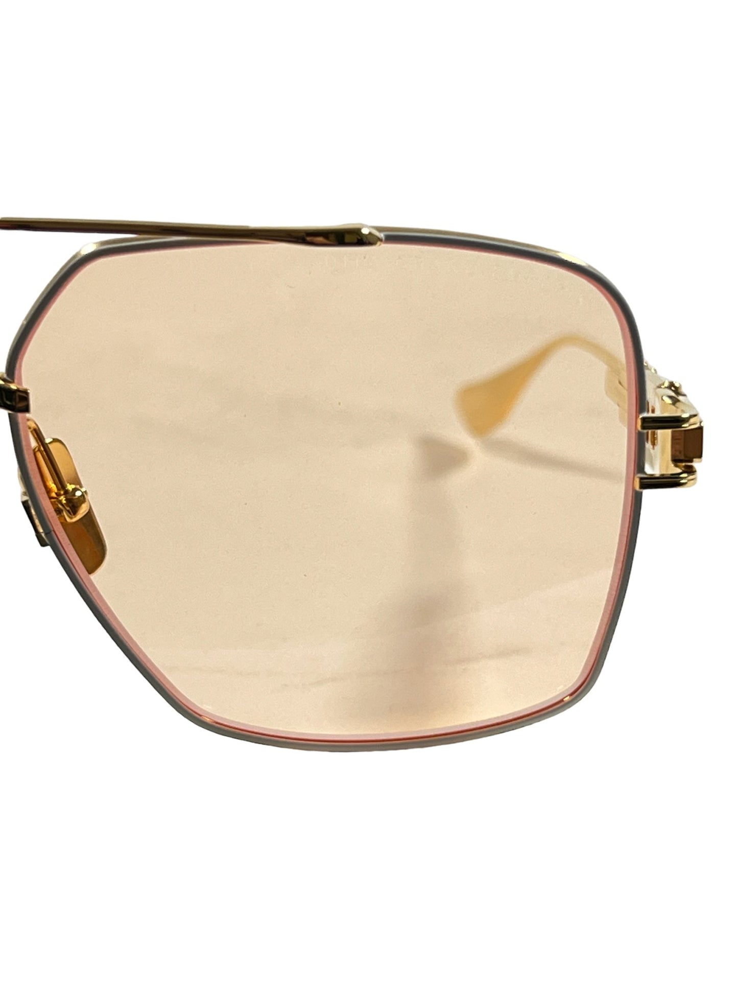 A pair of DITA luxury gold aviator sunglasses with titanium temples on a white background.