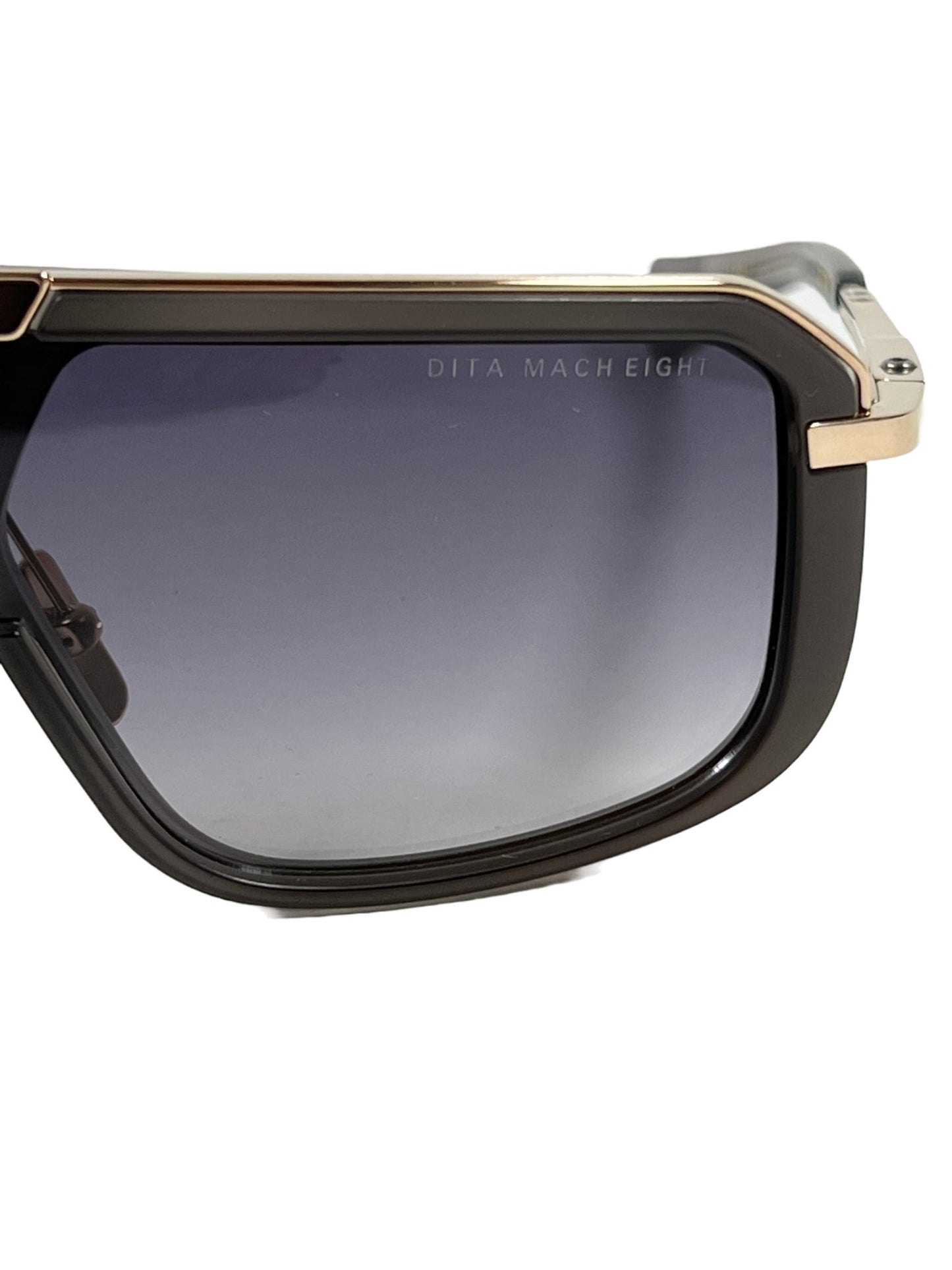 A pair of DITA DITA MACH-EIGHT DTS400-A-02 sunglasses with a black frame and gold trim, crafted in Japan.