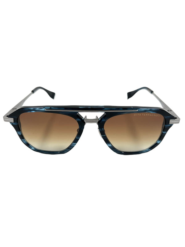 A pair of DITA sunglasses with a blue-yellow frame and brown lenses from Japan.