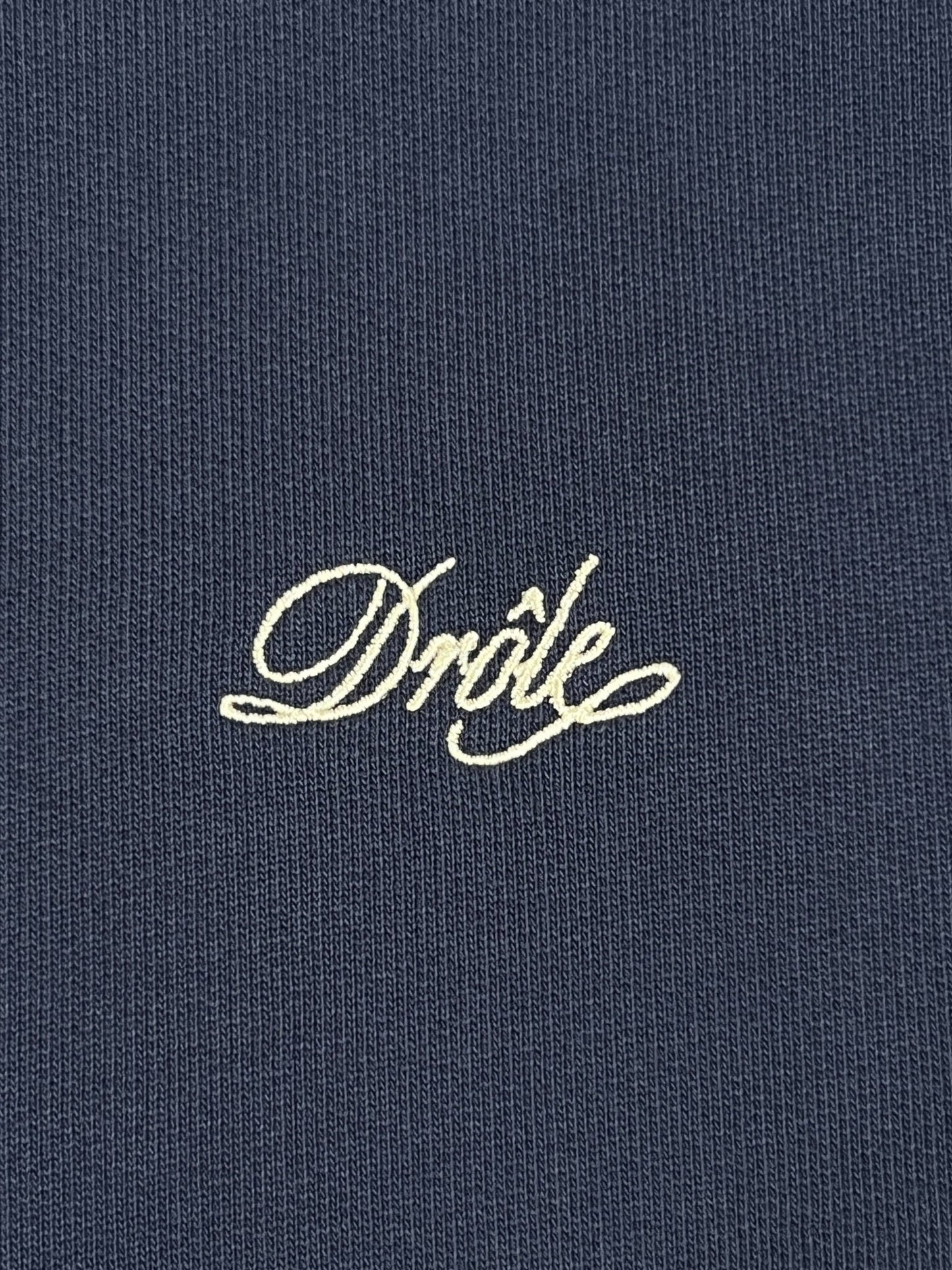 A close up of a Drole De Monsieur sweatshirt with the word dribe embroidered on it.