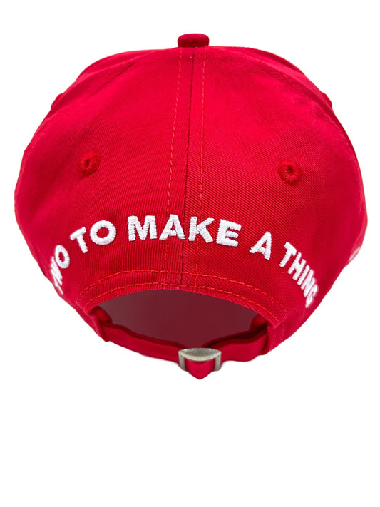 A red DSQUARED2 BCM0265 baseball cap with the words "do to make a thing" on it.