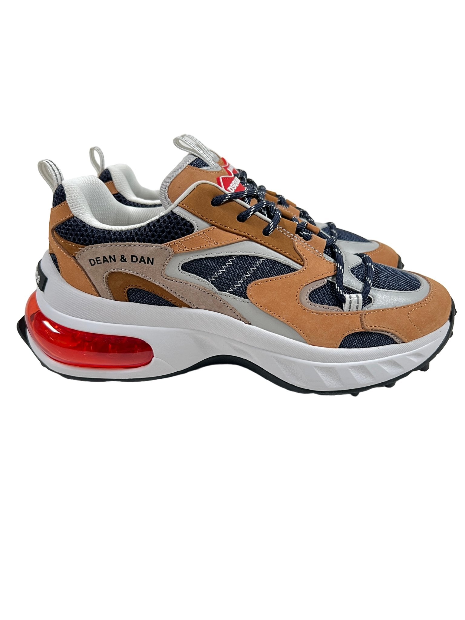 The Dsquared2 SNM0307 Sneakers by DSQUARED2 seamlessly combine beige, gray, and blue with mesh and nubuck leather panels, enhanced by striking red accents. The words "Dean & Dan" are displayed on the side, and the white soles showcase a prominent red air cushion for added style.