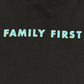 A black graphic FAMILY FIRST t-shirt with the word "family first" on it, made from 100% cotton.