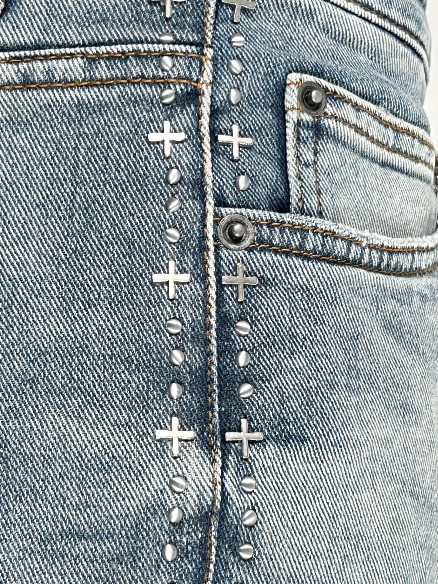 Close-up of a Ksubi BRONKO denim jeans seam with metal rivets and contrast stitching.