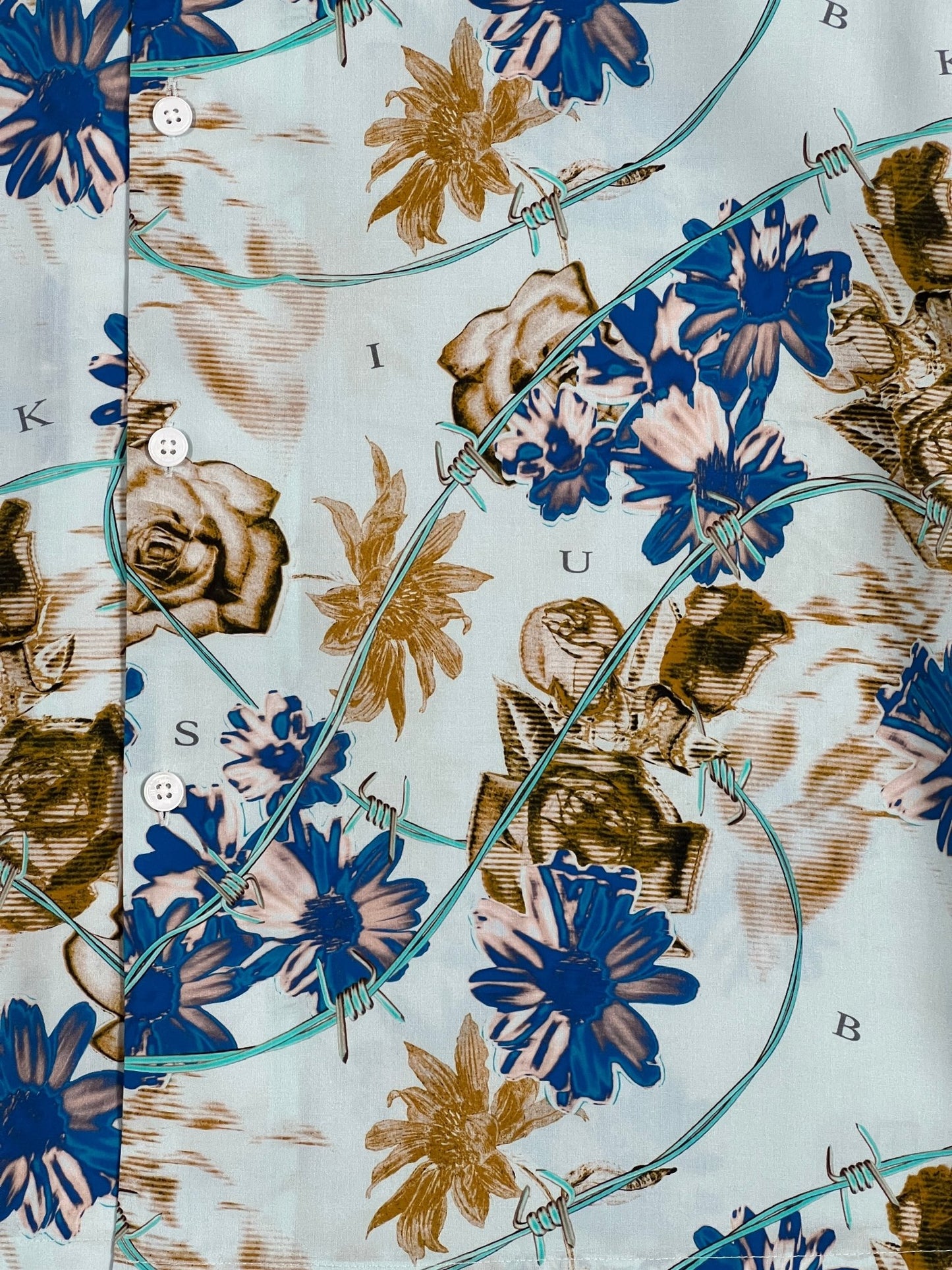 A KSUBI blue and brown short sleeve shirt with floral print on it.