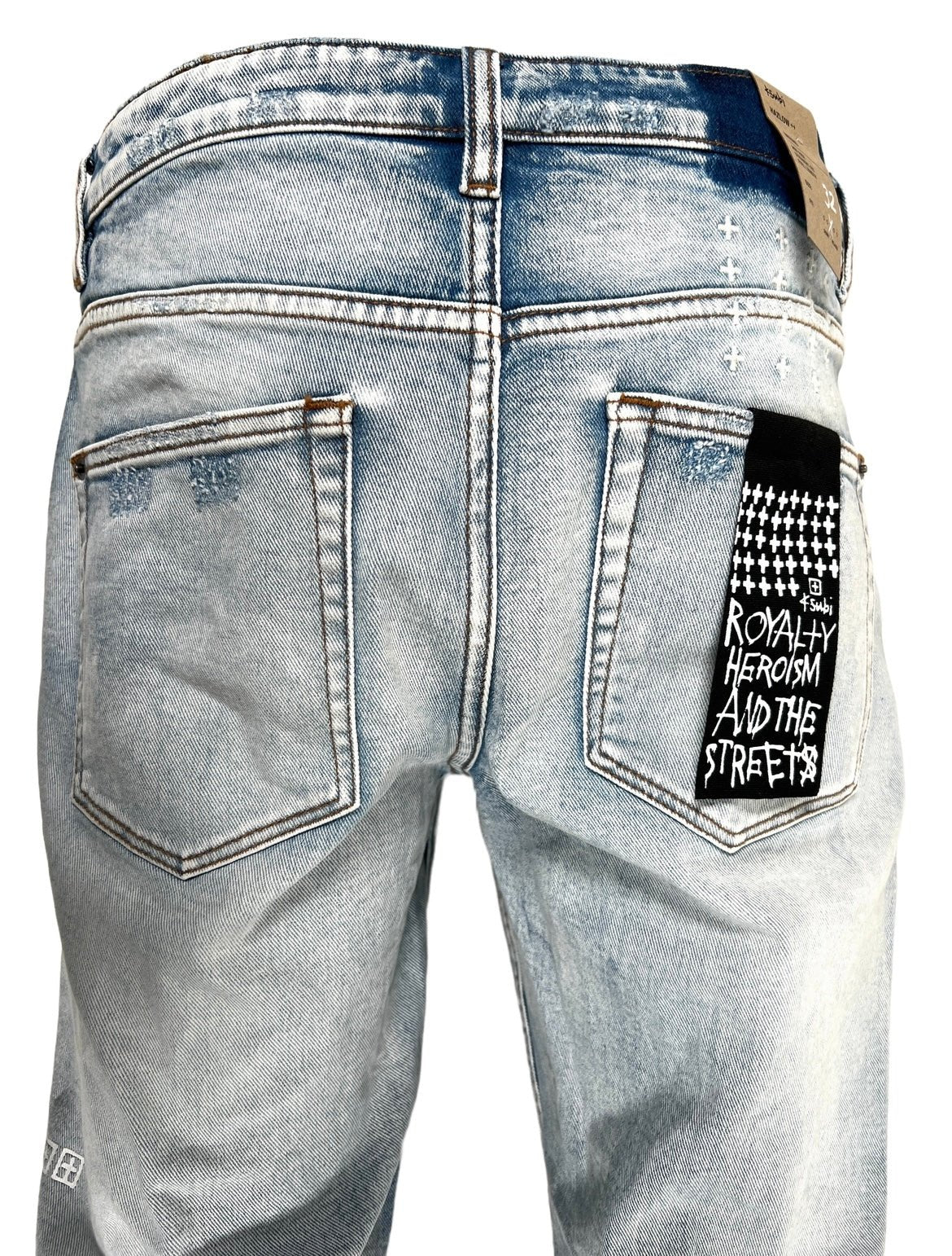 A pair of men's ripped jeans with a KSUBI HAZLOW CITY HIGH TRASHED DENIM tag on the back.