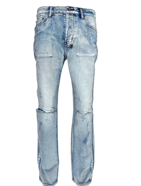 A pair of KSUBI HAZLOW CITY HIGH TRASHED DENIM men's jeans with ripped holes on the knees.