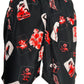 A black and red KSUBI ICONS BOARDSHORT BLACK with a floral print on it.